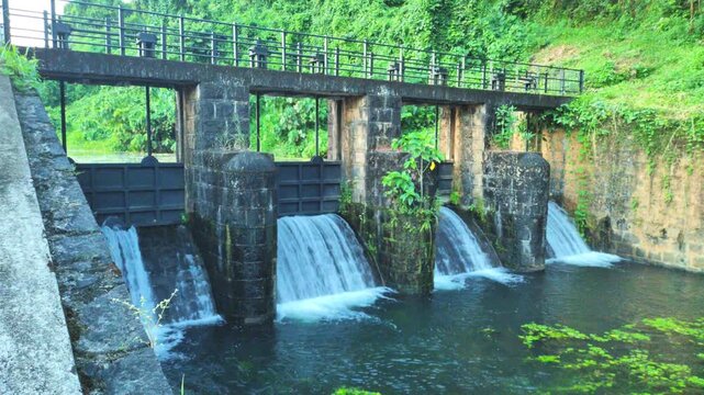 Historic Stone Dam Gates With Cascading Water at Poomala Dam, Thrissur Kerala, Scenic Small Irrigation Project Setting