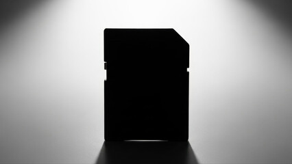 Silhouette of a card reader isolated on a white background with dramatic lighting and crisp shadows, emphasizing its rectangular shape