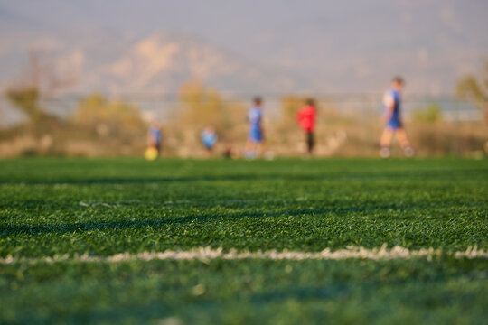 Group of young athletes practicing soccer on grass