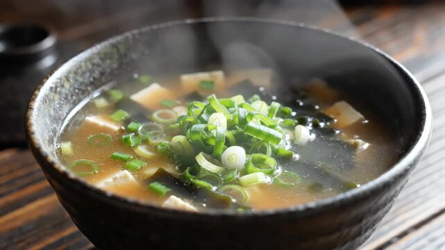 Steaming bowl of delicious Japanese miso soup with green onions