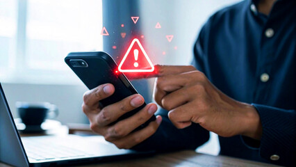 Man receives urgent alert on smartphone showing cybersecurity threat warning, symbolizing digital danger and security concerns