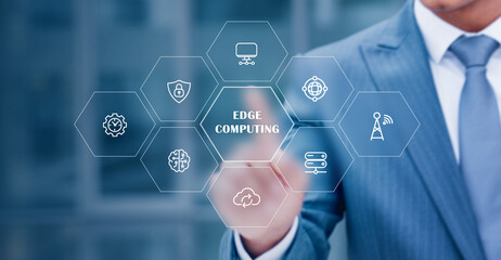 A businessman interacts with a digital edge computing interface representing faster data processing, IoT connectivity, network efficiency, and modern distributed technology solutions.