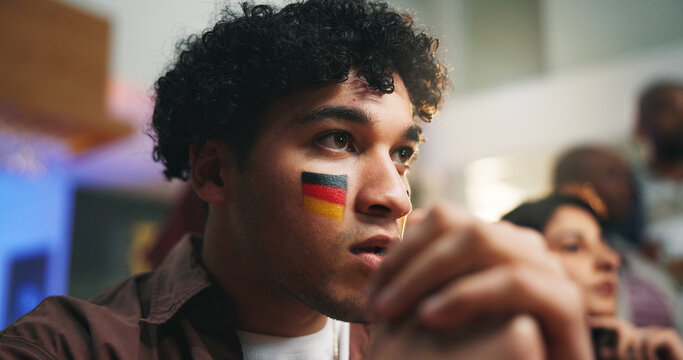 Sports, face paint and man in pub with suspense for score, waiting for goal and live streaming game. Bar, friends and people for team support, broadcast and match for social gathering in restaurant