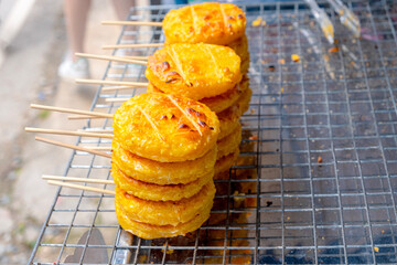 Grilled rice with eggs, stacked on a griddle, colorful and appetizing.
