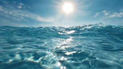 Sunlight sparkles on clear blue ocean water creating a serene scene. Gentle waves ripple under a bright sky making it a perfect day for relaxation by the coast.
