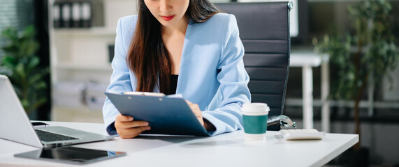 Businesswoman hand using laptop, tablet and smartphone in office. Digital marketing media mobile app and discussing plan new start up project.