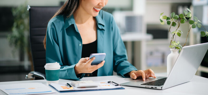Woman hand using smart phone, tablet payments and holding credit card online shopping, omni channel, digital tablet docking keyboard computer at office