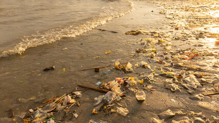 Plastic waste, plastic cups at the beach. Concept of environmental problems and saving the plane	