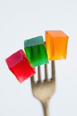 Vibrant Gelatin Cubes on a Gold Fork