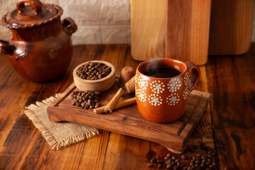 Cafe de Olla, traditional black Mexican coffee, spiced with cinnamon and piloncillo, prepared in a pot and served in a handmade clay cup called a jarrito.