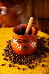 Cafe de Olla, traditional black Mexican coffee, spiced with cinnamon and piloncillo, prepared in a pot and served in a handmade clay cup called a jarrito.