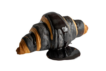 Delicious black and orange marble croissant with chocolate glaze isolated on transparent background