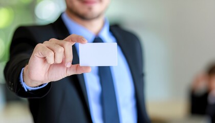 Business Card Showcase: A professional in a sharp suit extends a blank business card towards the viewer, symbolizing connection and opportunity.
