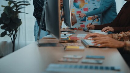 A vibrant office setting where a team of diverse professionals is engaged in brainstorming and problem-solving, using technology and creative tools to enhance productivity. SACTR