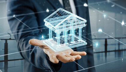 The Digital Hand of Finance: A striking composite image presents a man's hand holding a glowing digital representation of a building, highlighting concepts of finance and innovation.