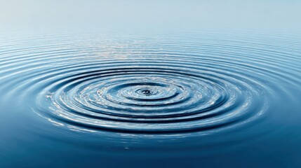 Fototapeta premium A tranquil scene shows a smooth water surface with concentric ripples expanding outward. The sky is light blue with fluffy white clouds creating a peaceful atmosphere.