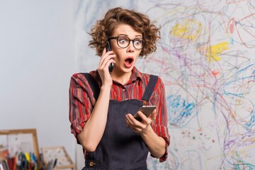 Colorful Workspace with a Surprised Woman Talking on the Phone