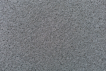 Close-up photo of gray doormat fibers