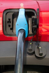 An electric car connected to a DC fast charging station, showing modern energy technology, sustainable transport, and the innovation behind clean electric mobility