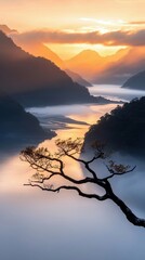 A tree branch extends over a misty mountain landscape at sunrise, with a river winding through the valley. The sky is filled with warm colors.