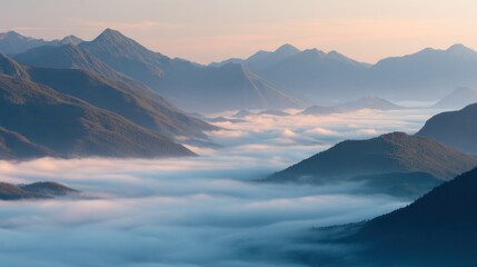 Fototapeta premium Soft morning light illuminates the mountain ranges as fog rolls through the valleys creating a tranquil and captivating natural scene at sunrise.