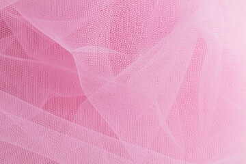 large folds of the bride's white veil on a pink background. Abstract wedding background with copy space. Mockup for wedding design.