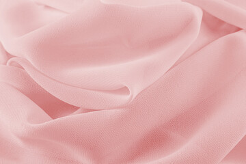 Luxurious design of pink background soft silk fabric. delicate waves of chiffon material. The...