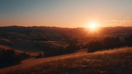 Obraz premium Golden Sunset Over Rolling Hills and Vast Landscape.