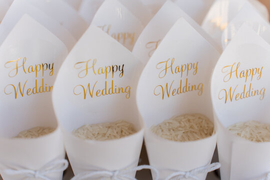 Rice cones with Happy Wedding messages ready for guests at a beautiful outdoor wedding ceremony
