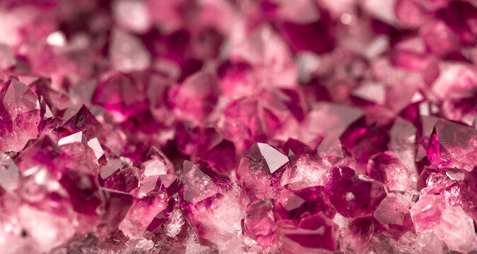 Amethyst garnet crystals. Burgundy gemstone. Mineral crystals in the natural environment. Texture of precious and semiprecious stones. Colored shiny surface of precious stones.