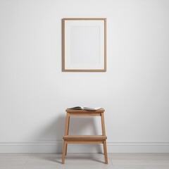 Simple Modern Interior: A minimalist interior setup, featuring a wooden frame suspended on the wall above a small, rustic wooden step stool. With an open book resting on the stool.