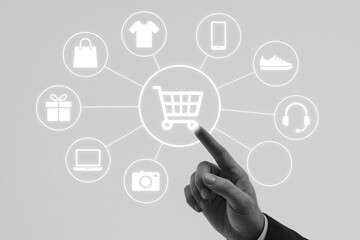 Naklejka premium Hand selecting shopping cart icon among various consumer products in a digital interface. Concept of e-commerce, online shopping, and consumer behavior in a modern marketplace.