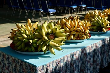 yellow and green asian bananas on banana leaves and blurry background