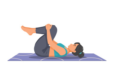 Woman practicing yoga doing wind relieving pose on the mat