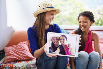 Happy kids, tablet screen and photo with friends in home, laughing and social media selfie. Tech, girls and show profile picture in house with teenager for funny memory, capture moment and bonding