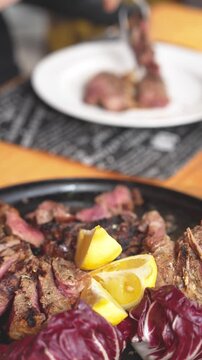 Close up of sliced tagliata beef steak served on a plate in fine dining restaurant
