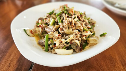 Thai Spicy Minced Pork Salad ( Laab or Larb Moo). : A mouthwatering plate of expertly prepared dish, a symphony of flavors and textures, ready to be savored.