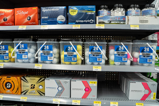 View of assorted golf balls and tees displayed on store shelves. Toronto, Canada - November 26, 2025.