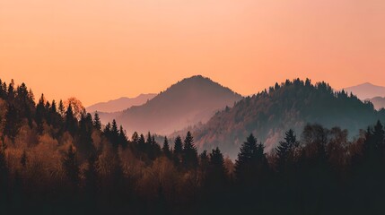 Misty Mountain Landscape at Sunrise with Silhouetted Trees.
