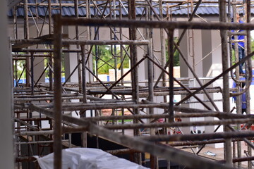 Silhouette of construction workers on scaffolding