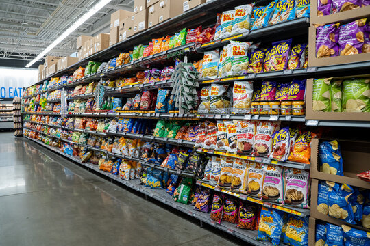 View of assorted packaged chips and snacks on supermarket shelves. Toronto, Canada - November 26, 2025.