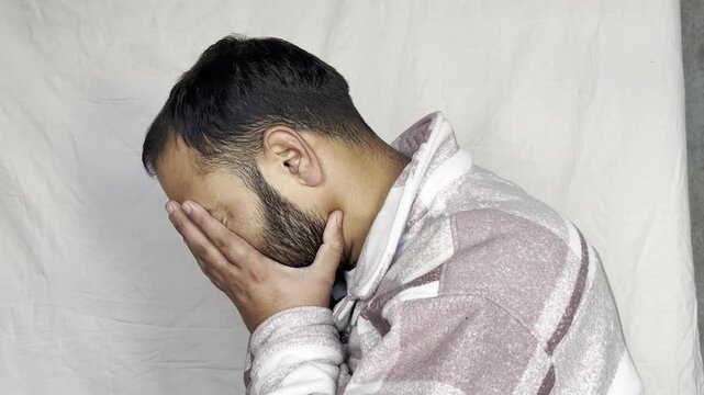 Caucasian man sitting on bed holding head grief pain crisis separation fatigue headache burnout bedroom guy male emotional stress tired exhaustion sadness anxiety distraught problems overworked loss