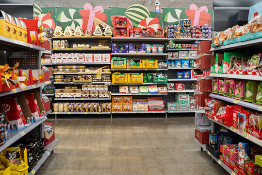 Wide view of assorted holiday candy and chocolate products on store shelves. Toronto, Canada - November 26, 2025.