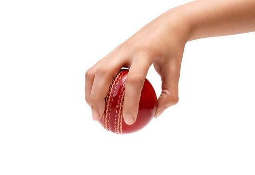 Hand gripping a red cricket ball, ready for action a