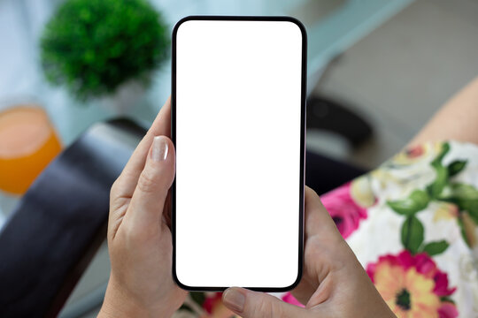 Female hands holding phone with isolated screen over colorful dress