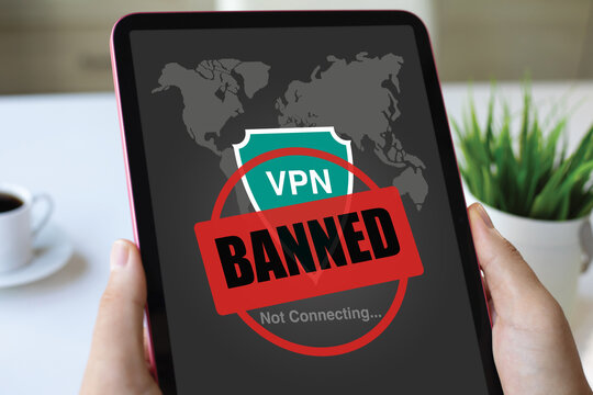 male hands holding computer tablet with VPN banned of screen