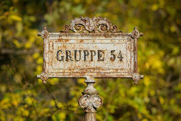 Old iron sign group graves Zentralfriedhof Vienna Austria autumn day colorful foliage