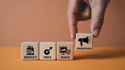 Human hand places a wooden block representing promotion alongside blocks depicting core business marketing concepts