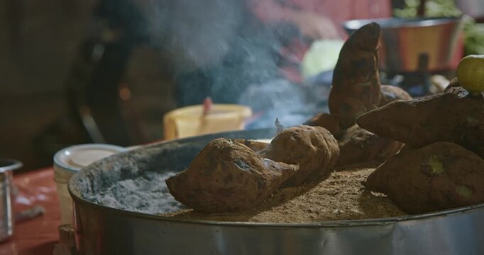 Heat of Street Food Preparation with Sweet Potatoes Roasting