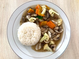 A simple Indonesian dish featuring stir-fried mixed vegetables served with a side of fluffy white rice